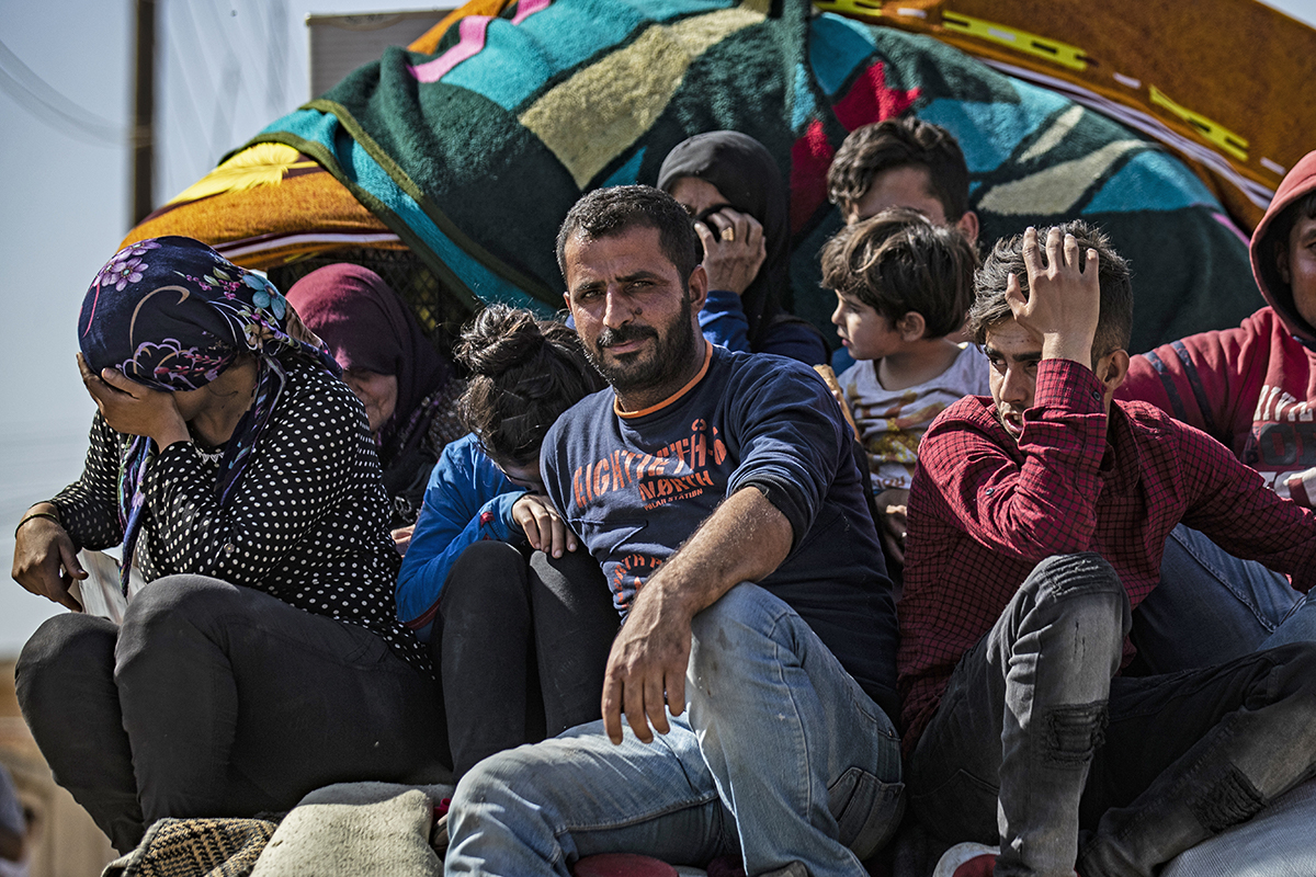 Syrian Arab and Kurdish civilians arrive to Hassakeh city after fleeing following Turkish bombardment on Syria''s northeastern towns along the Turkish border on October 10, 2019. - Syria''s Kurds battle