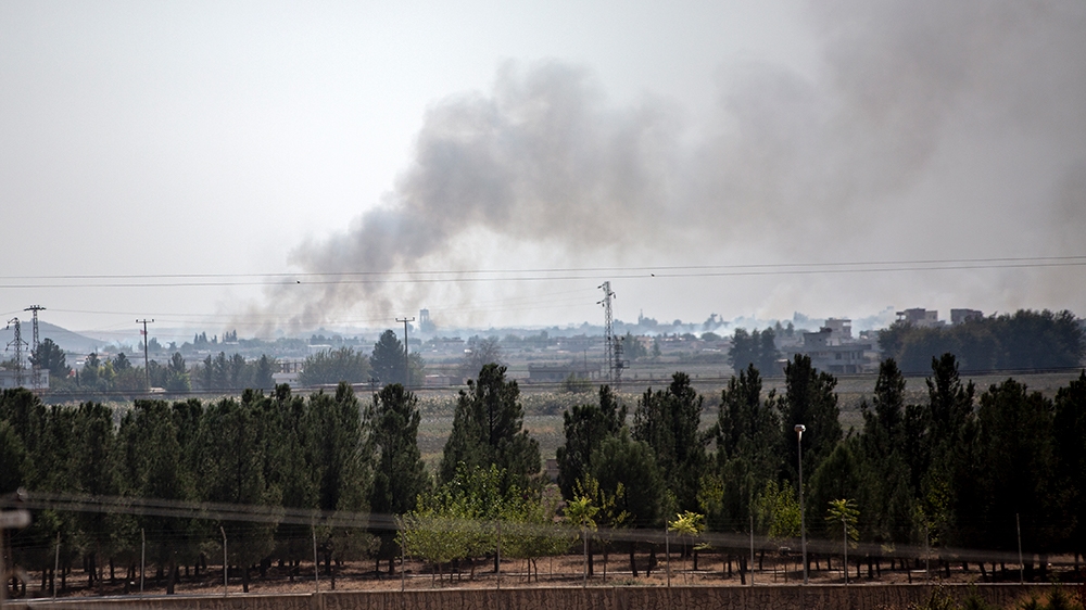 Smoke rises from the northeastern Syrian town of Tal Abyad [Hosam Salem/Al Jazeera] 