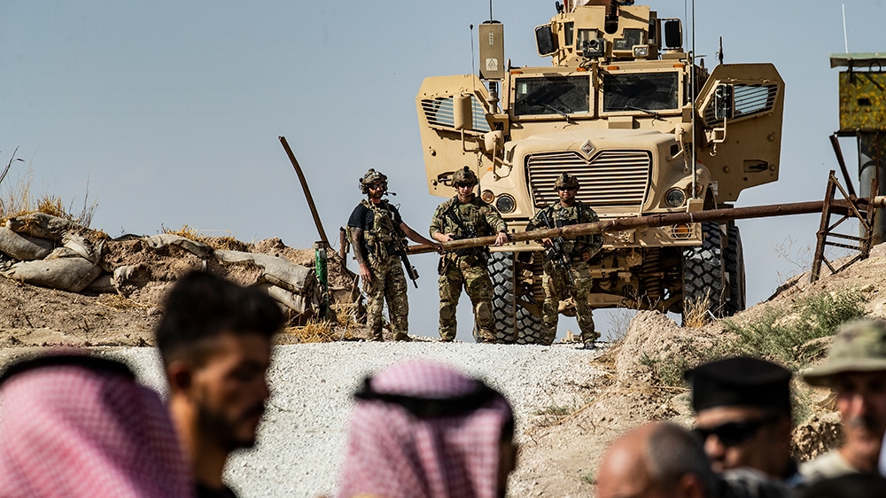Syrian Kurds take part in a demonstration against Turkish threats at a US-led international coalition base on the outskirts of Ras al-Ain town in Syria''s Hasakeh province near the Turkish border on Oc