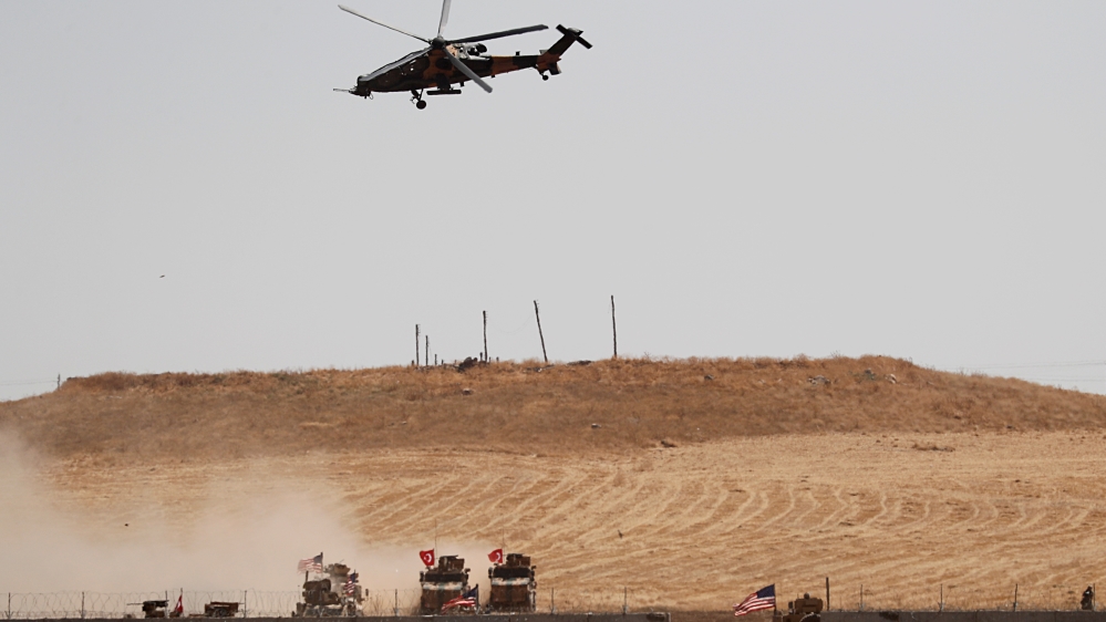 Turkish military helicopter flies over as Turkish and U.S. troops return from a joint U.S.-Turkey patrol in northern Syria, as it is pictured from near the Turkish town of Akcakale, Turkey,