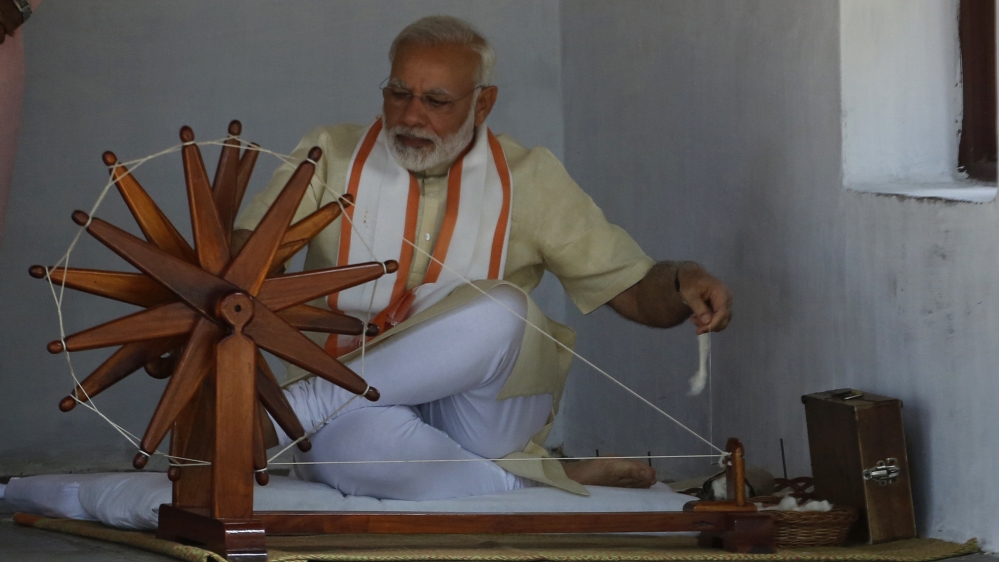 Indian prime minister Narendra Modi tries his hands on a spinning wheel during his visit to Gandhi Ashram, a residence of Mahatma Gandhi, in Ahmadabad, India, Thursday, June 29, 2017. Modi has condemn