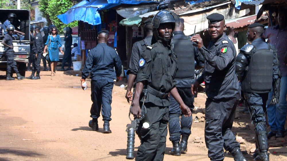 Police officers deploy outside a court in Conakry