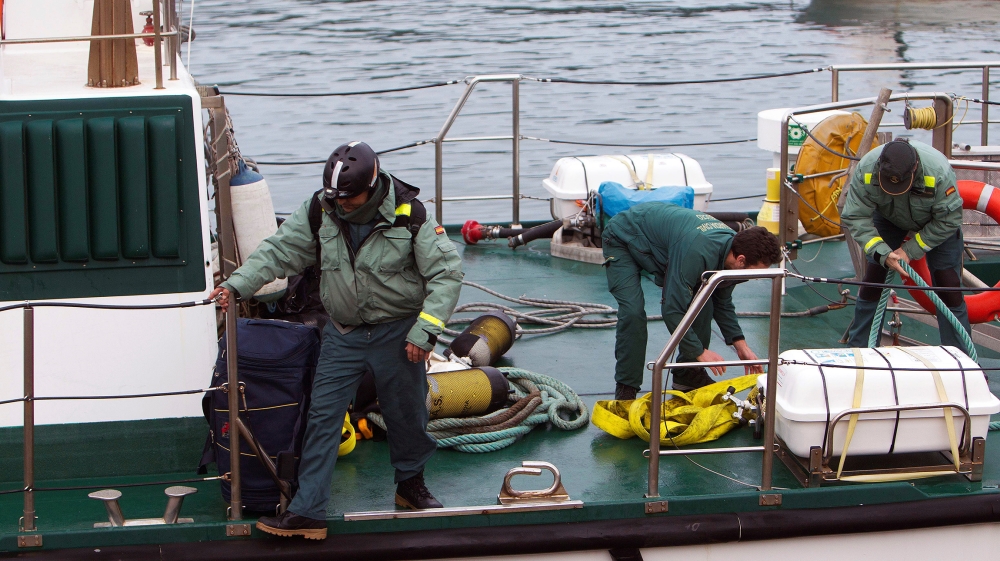 Agents of the Underwater Activities Special Group, of the Spanish Civil Guard, start operations to afloat a submarine containing 3,000 kilos of cocaine immersed in the estuary of Aldan river at the Ga