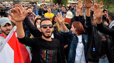 Protesters shout slogans as they block the highway leading to the Presidential palace during a protest to demand the formation of a new government in Baabda, east Beirut, Lebanon, 26 November 2019. Pr