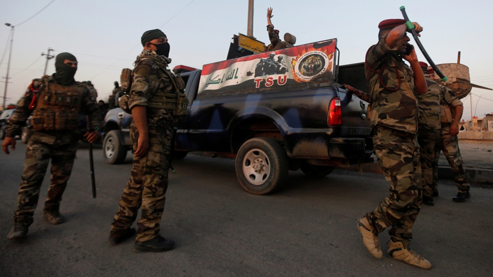 Members of Iraqi security forces are seen during the ongoing anti-government protests in Basra
