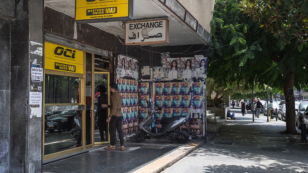 A pedestrian enters a Western Union Co. currency exchange store on Hamra Street in Beirut, Lebanon, on Tuesday, July 24, 2018.