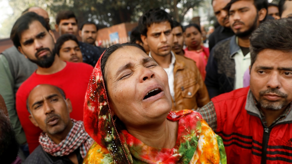 A relative of a victim of a fire that swept through a factory where laborers were sleeping, cries outside a hospital mortuary in New Delhi, India December 8, 2019. REUTERS/Adnan Abidi