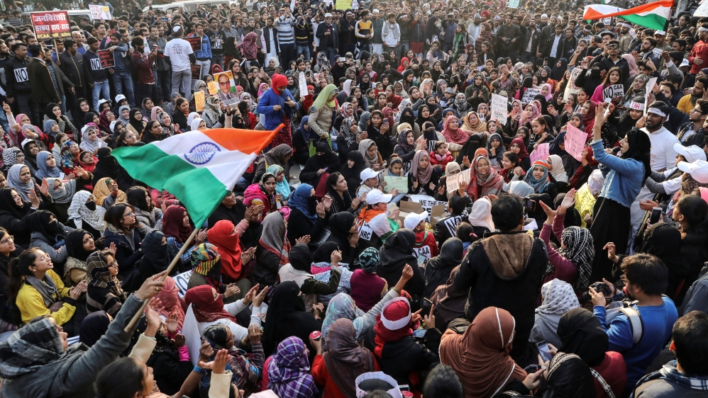 Demonstrators attend a protest against a new citizenship law, outside the Jamia Millia Islamia University in New Delhi