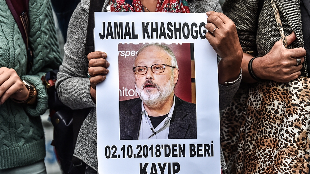 A woman holds a portrait of missing journalist and Riyadh critic Jamal Khashoggi reading "Jamal Khashoggi is missing since October 2" during a demonstration in front of the Saudi Arabian consulate on