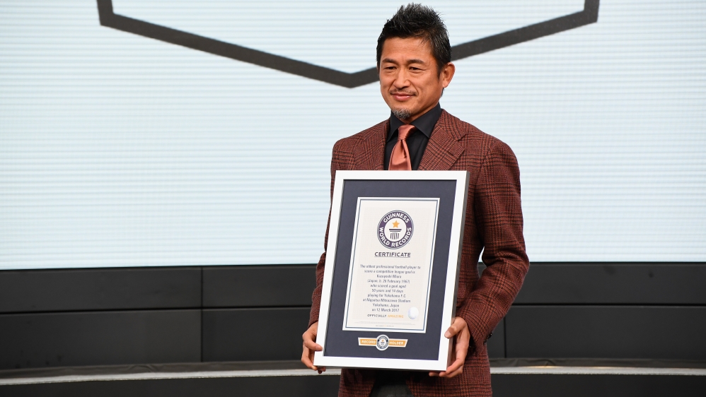 Miura poses with the Guinness World Record certificate for being the ‘Oldest professional football player to score a competitive league goal’ on February 15, 2018