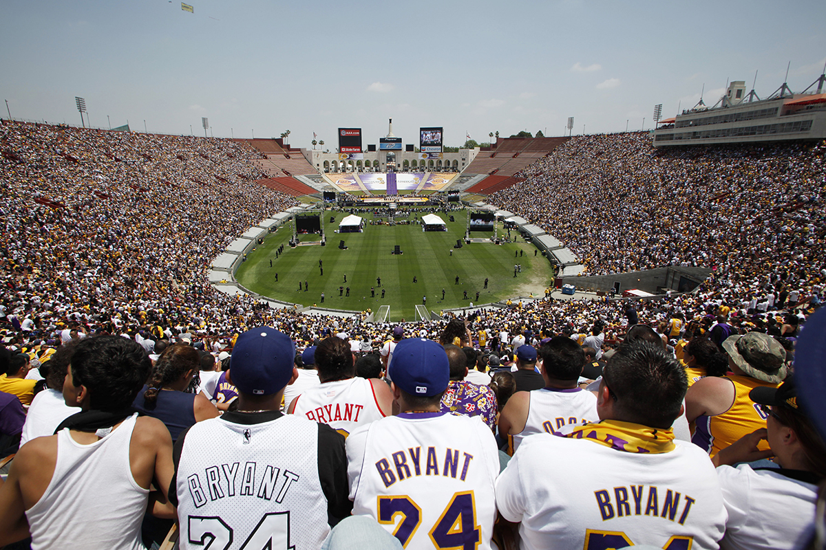 Fans wear Kobe Bryant jerseys at a rally in the Los Angeles Memorial Coliseum after the team paraded down Figueroa Street from Staples Center to the Coliseum as the Los Angeles Lakers celebrate their