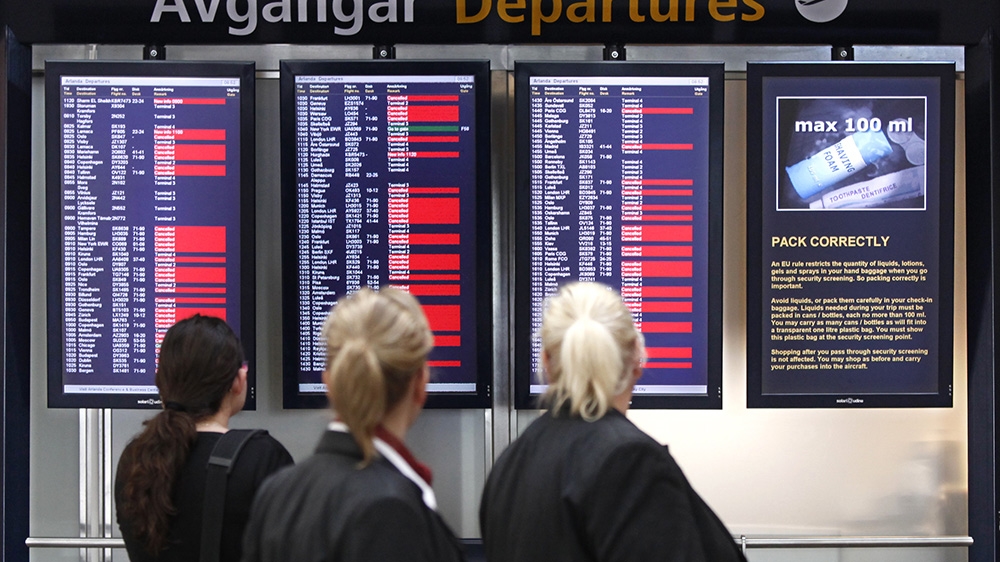 Travelers and airline staff check the departure board as flights continued to be delayed and cancelled at Stockholm''s Arlanda Airport April 19, 2010.