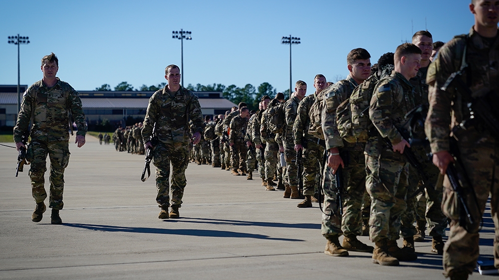U.S. Army paratroopers assigned to the 1st Brigade Combat Team, 82nd Airborne Division, walk toward an awaiting aircraft prior to departing for the Middle East from Fort Bragg, North Carolina, U.S. Ja