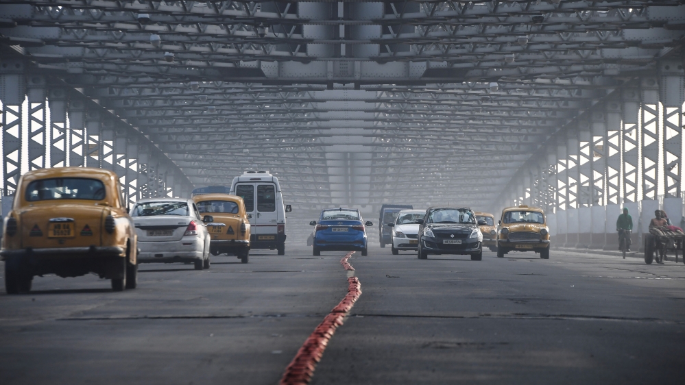 Commuters make way on the Howrah bridge during a nationwide general strike called by trade unions aligned with opposition parties to protest the Indian government's economic policies, in Kolkata on Ja