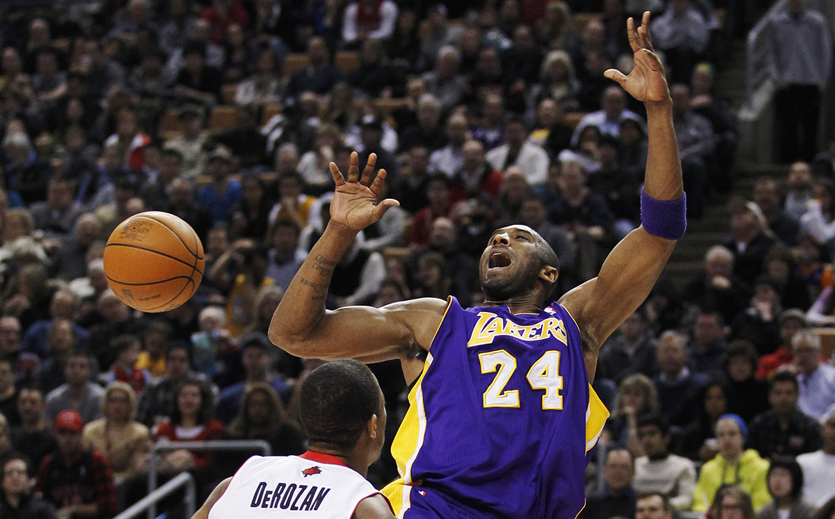 Los Angeles Lakers shooting guard Kobe Bryant has the ball swatted away by Toronto Raptors shooting guard DeMar DeRozan (L) during the first half of their NBA basketball game in Toronto, February 12,