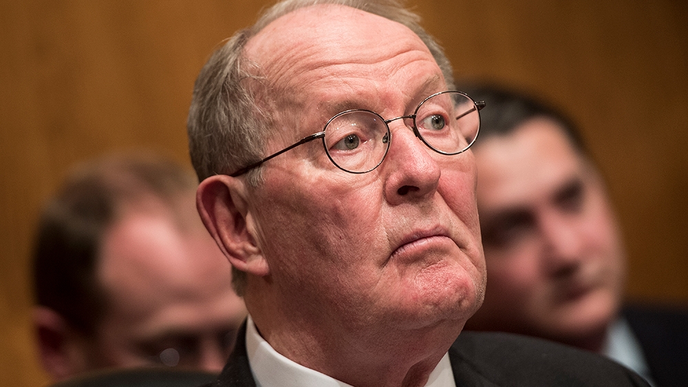 Committee chairman Senator Lamar Alexander (R-TN) listens while Betsy DeVos speaks during her confirmation hearing for Secretary of Education before the Senate Health, Education, Labor, and Pensions 