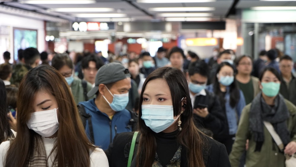 Passengers wear masks to prevent an outbreak of a new coronavirus in a subway station in Hong Kong