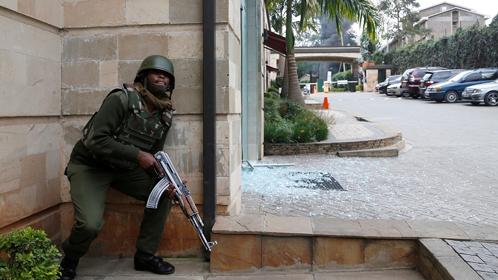 A policeman takes position at the scene where explosions and gunshots were heard at the Dusit hotel compound, in Nairobi, Kenya January 15, 2019. REUTERS/Baz Ratner