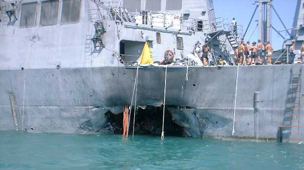 A gaping hole estimated at 40 feet wide and 40 feet high is visible in the left side of the hull of the U.S. warship USS Cole after it was attacked by terrorists in a small boat who maneuvered alongsi