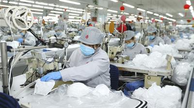 In this photo released by Xinhua News Agency, workers produce face masks in the workshop of a textile company in Jimo District of Qingdao in eastern China''s Shandong Province on Wednesday, Feb. 12, 20