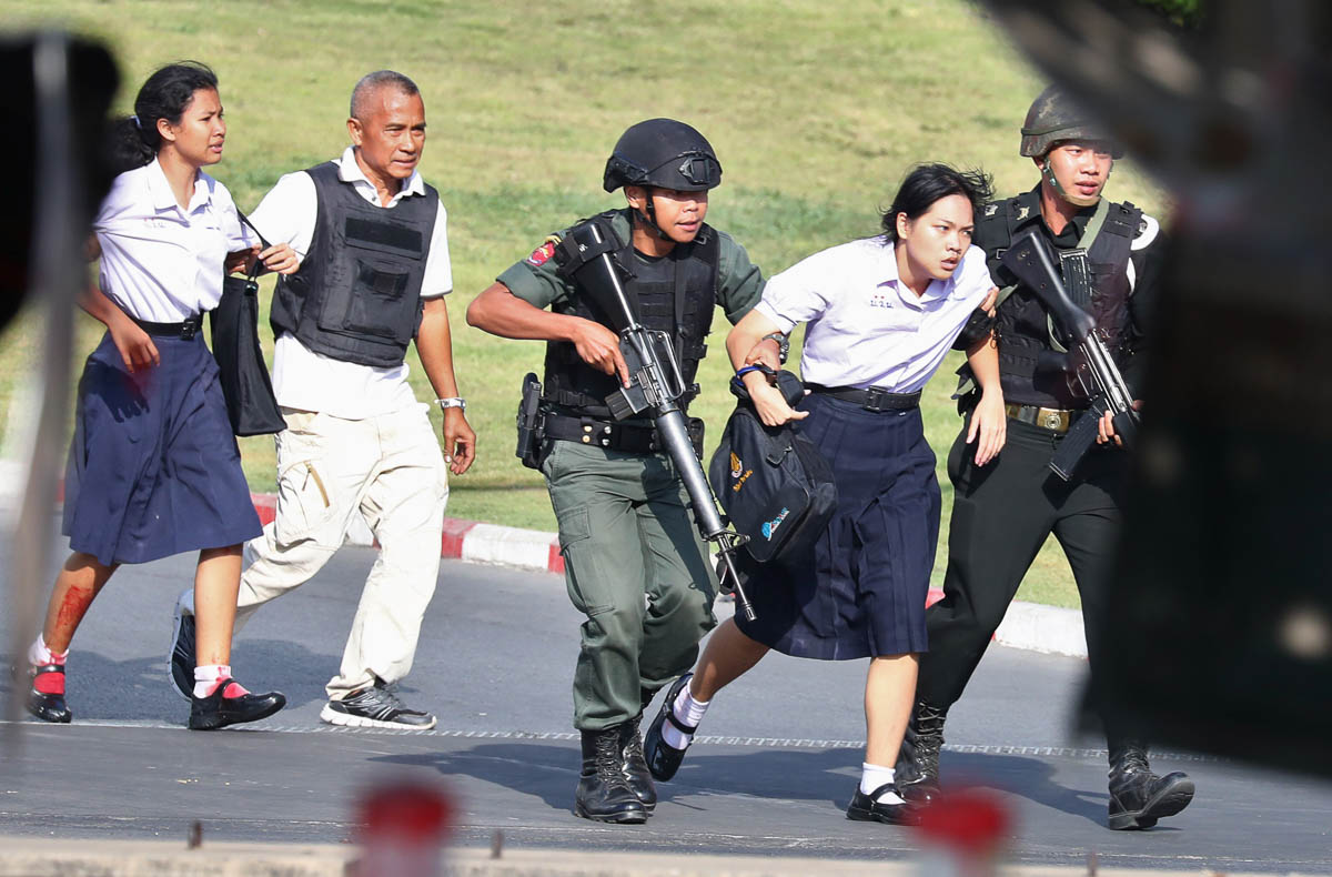 Thai security forces evacuate students stranded inside the Terminal 21 shopping mall following a gun battle to try to stop a soldier on a rampage after a mass shooting, Nakhon Ratchasima, Thailand Feb