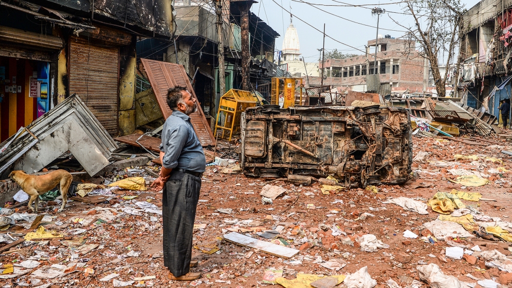 A resident look at burnt-out and damaged residential premises and shops following clashes between people supporting and opposing a contentious amendment to India''s citizenship law, in New Delhi on Feb