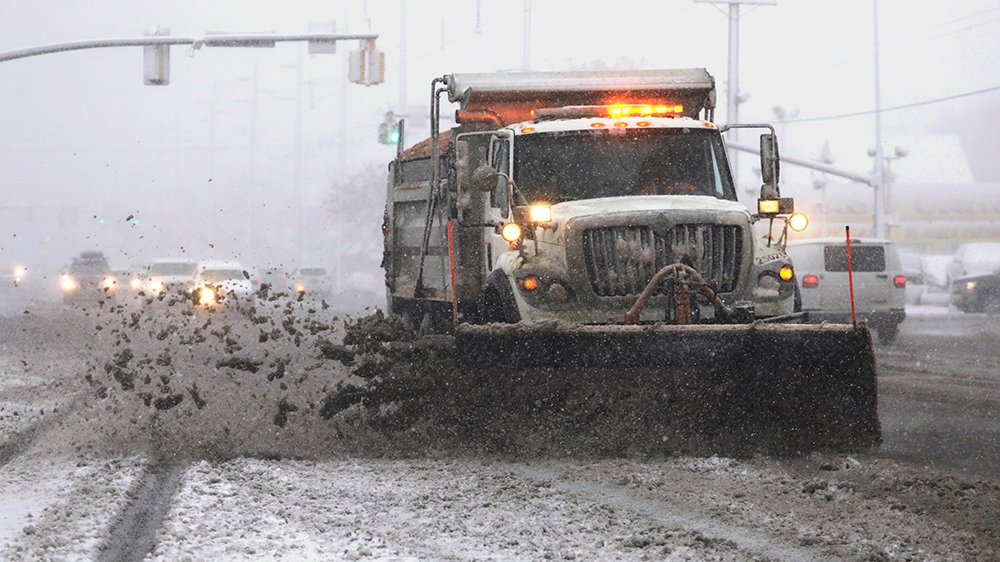 A snowplow clears a street as snow fall hampers the morning commute Friday, Jan. 17, 2020, in Salt Lake City. The storm dropped up to five inches (13 centimeters) within about four hours, said Nationa
