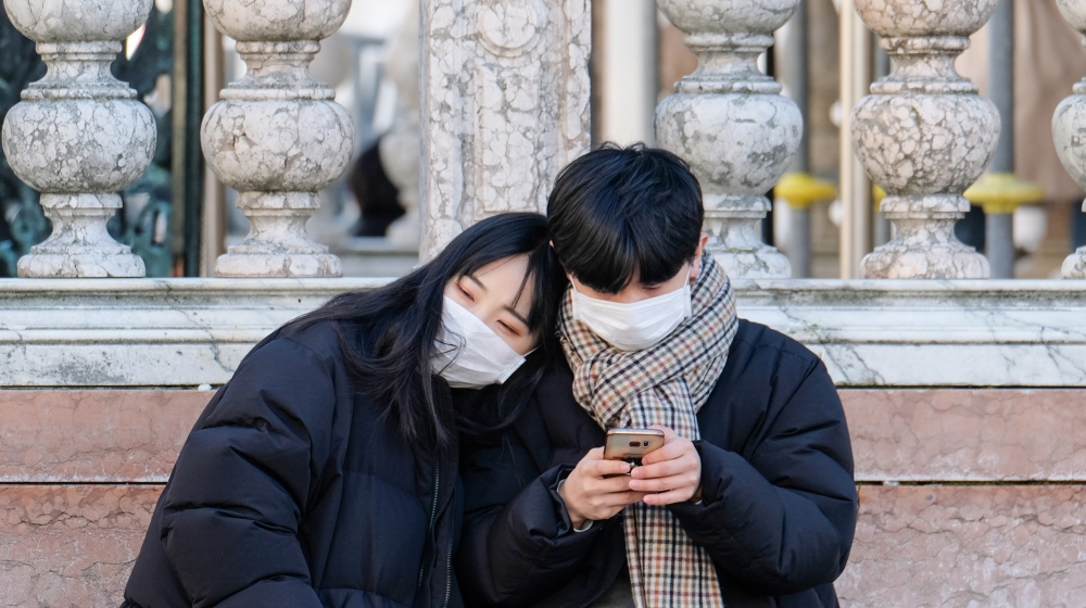 Tourists wear protective masks in Venice, Italy, February 6, 2020. Floods in November and fears of the spread of coronavirus have caused a 10 percent decline in hotel bookings ahead of the Venice carn