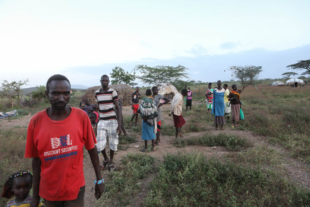 epa08137545 Villagers at Tungai Manyatta village which was also invaded by desert locust gather around after an invasion in Shaba National Reserve in Isiolo, northern Kenya, 16 January 2020 (issued 18
