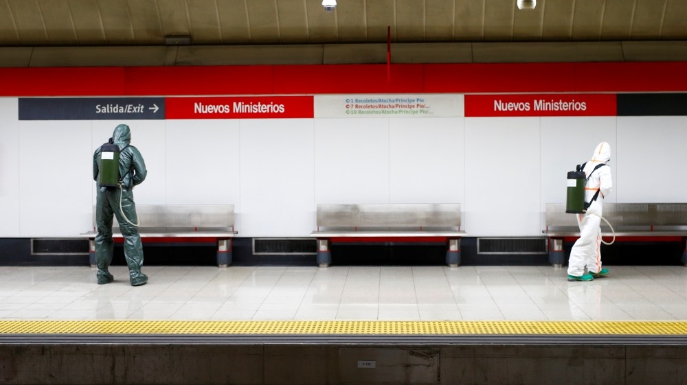 Military Emergency Unit members disinfect Nuevos Ministerios metro station during a partial lockdown as part of a 15-day state of emergency to combat the spr
