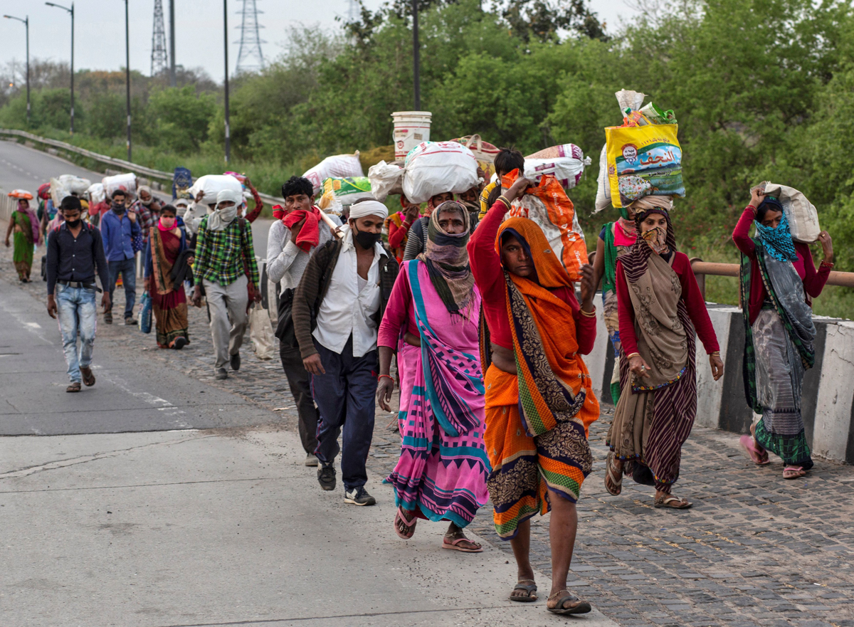 Migrant workers walk along a road to return to their villages, during a 21-day nationwide lockdown to limit the spreading of coronavirus disease (COVID-19), in New Delhi, India, March 26, 2020. REUTER