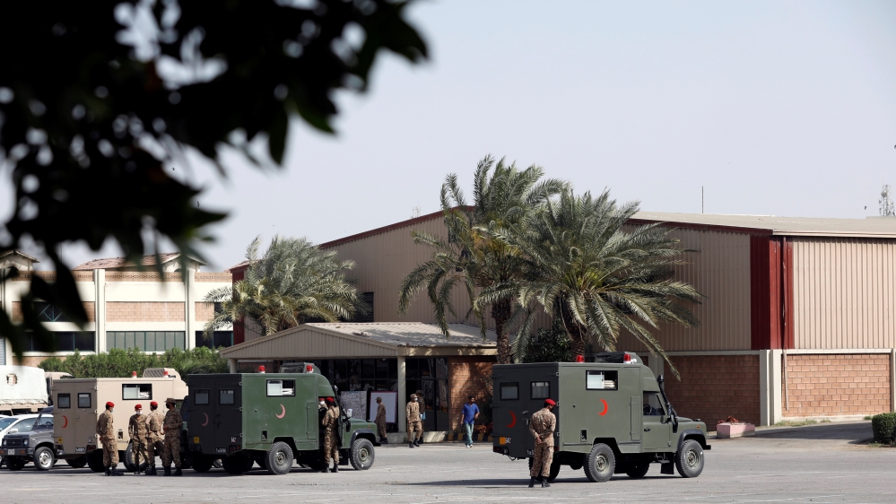 Military officers stand near parked ambulances at the premises of the Expo Center, after government declared it a mass isolation center and field hospital following an outbreak of the coronavirus