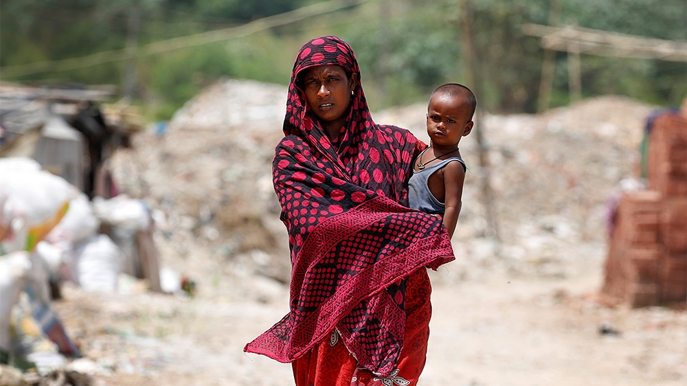 A woman from the Rohingya community walks through a camp in Delhi, India August 17, 2017. REUTERS/Cathal McNaughton