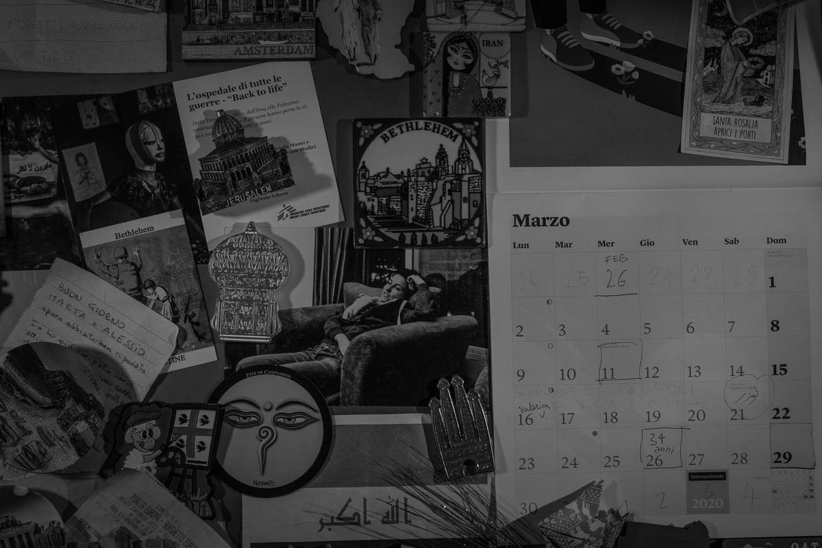 Calendar of March 2020, magnets and various objects hanging on the fridge at home, most of the items have been bought during their reporting travels or offered from their friends travelling around the