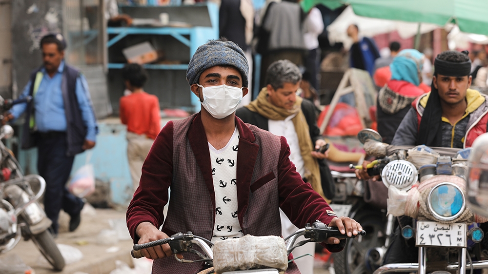 A man wears a protective face mask as he rides a motorcycle amid fears of the spread of the coronavirus disease (COVID-19) in Sanaa, Yemen March 16, 2020. Picture taken March 16, 2020. REUTERS/Khaled