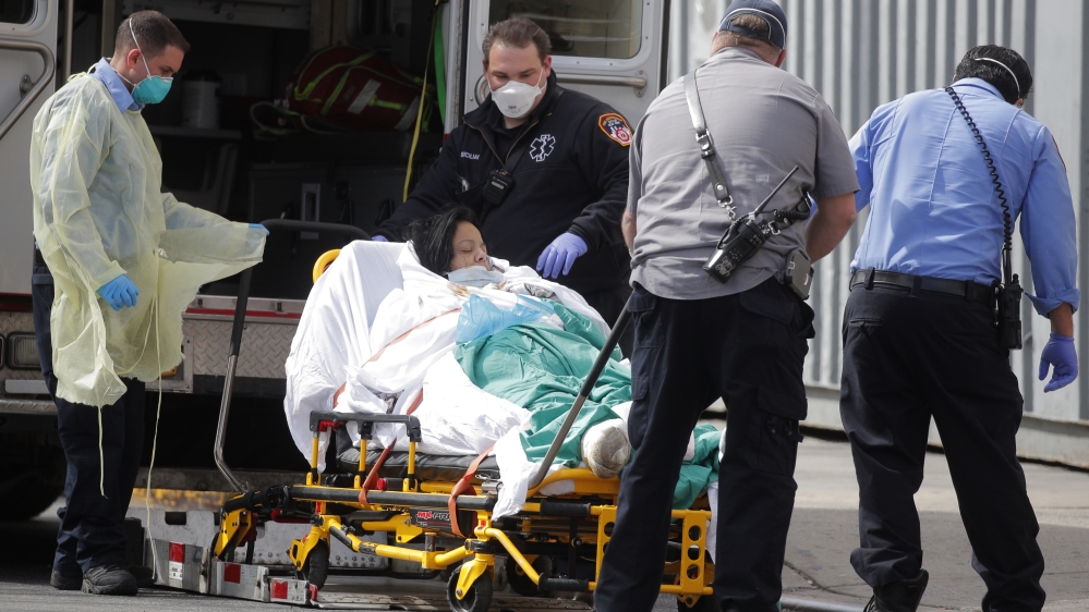EMT's transport patient into Bronx-Lebanon Hospital during outbreak of coronavirus disease (COVID-19) in the Bronx borough of New York