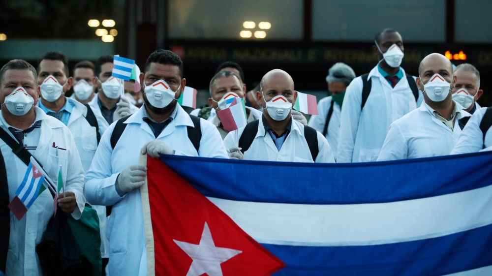 Medics and paramedics from Cuba pose upon arrival at the Malpensa airport of Milan, Italy in March