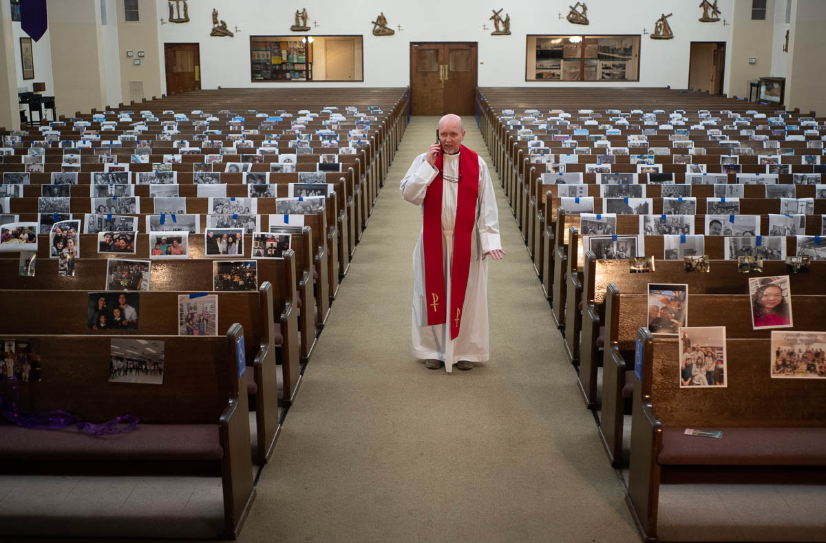 The Rev. Nicolas Sanchez takes a phone call from a parishioner after live-streaming the Good Friday Mass at St. Patrick''s Catholic Church in Los Angeles on Friday, April 10, 2020. The COVID-19 measure