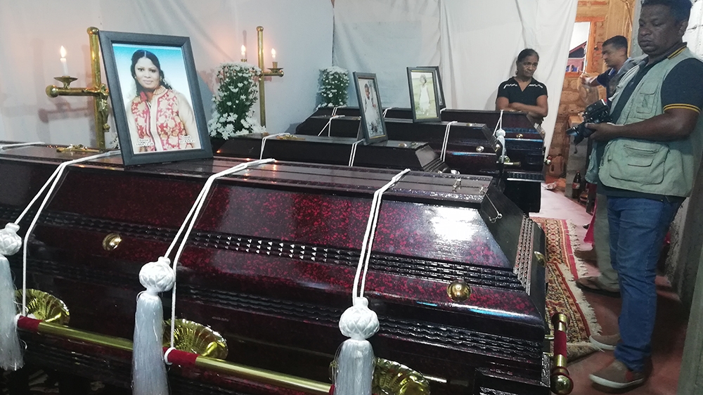 The coffins of the four family members [Aanya Erinyes/Al Jazeera]