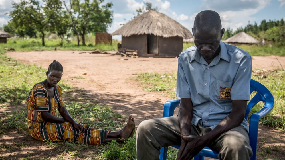 Jeanette Aromorach and Hillary Daniel Lagen, the parents of a 12-year-old who died after he was unable to reach hospital because of Uganda's transport ban. [Sally Hayden/Al Jazeera]