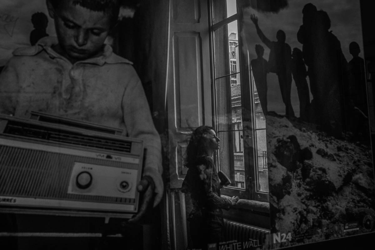 Marta reflected in a painting at home as she dries her hair in front of the window. For the first two weeks after suffering symptoms from Covid-19, Marta hasn''t been able to concentrate in any activit