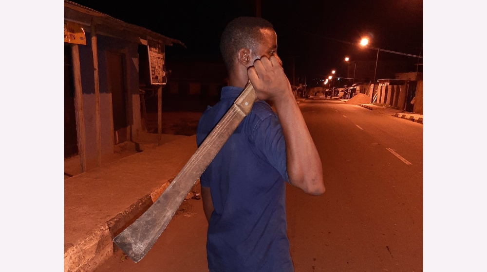 Businessman Awosusi Ahmed keeping vigil in front of his Lagos home.