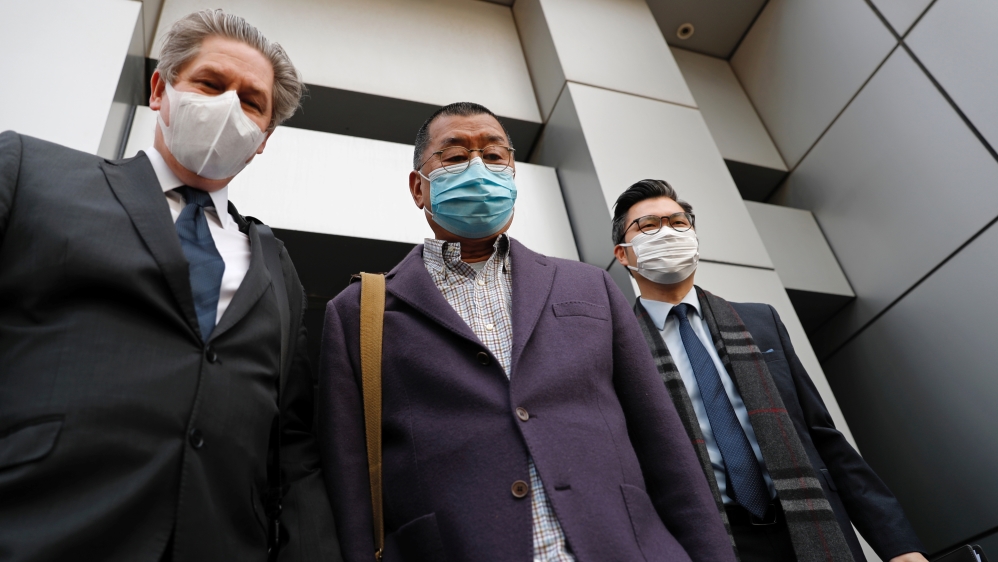 Media mogul and Apple Daily founder Jimmy Lai Chee-ying (C) leaves from a police station after being arrested for illegal assembly during the anti-government protests in Hong Kong