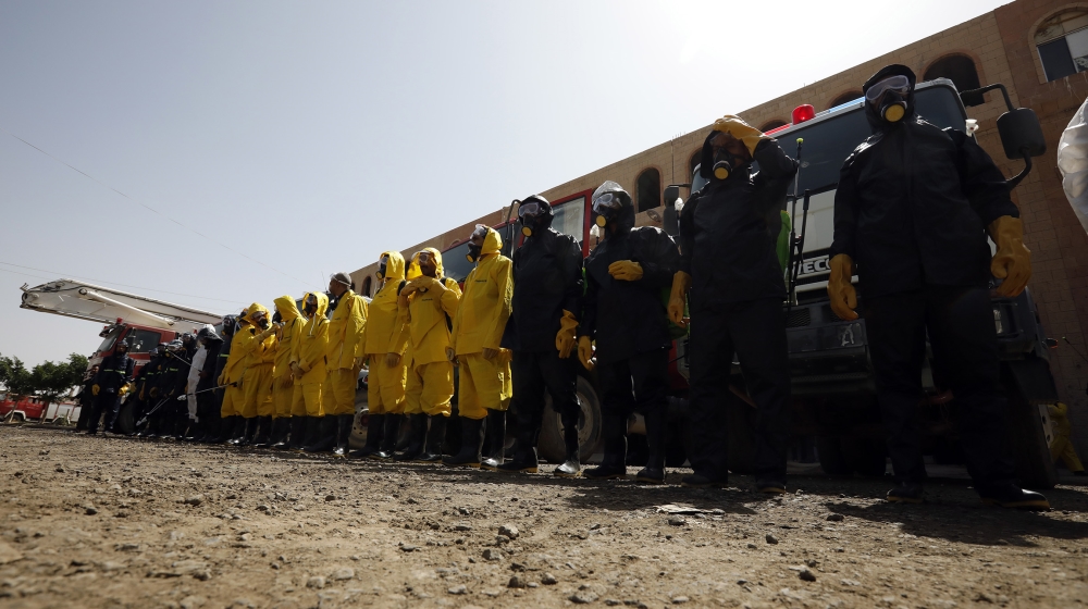 Staff of the Yemeni civil defense wearing protective gear, prepare to spray disinfectant during a demonstration of an anti-proliferation training of the SARS-CoV-2 coronavirus, in Sanaa, Yemen, 12 Apr