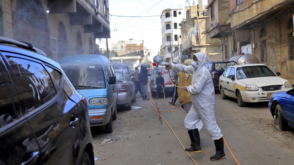 Yemeni workers spray disinfectant in a neighbourhood of the capital Sanaa, on May 11, 2020, during an emergency lockdown in certain areas due to the ongoing COVID-19 pandemic. Mohammed HUWAIS / AFP