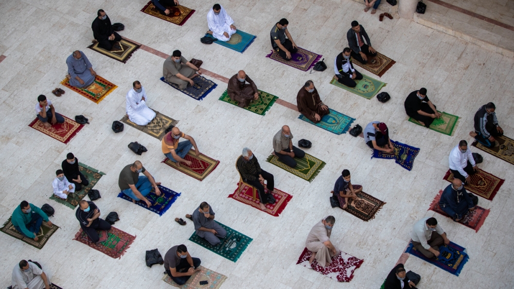 Palestinians wearing face masks attend the Eid al-Fitr prayers outside a mosque in Gaza City, Sunday, May. 24, 2020. Millions of people in the world's largest Muslim nation are marking a muted and glo