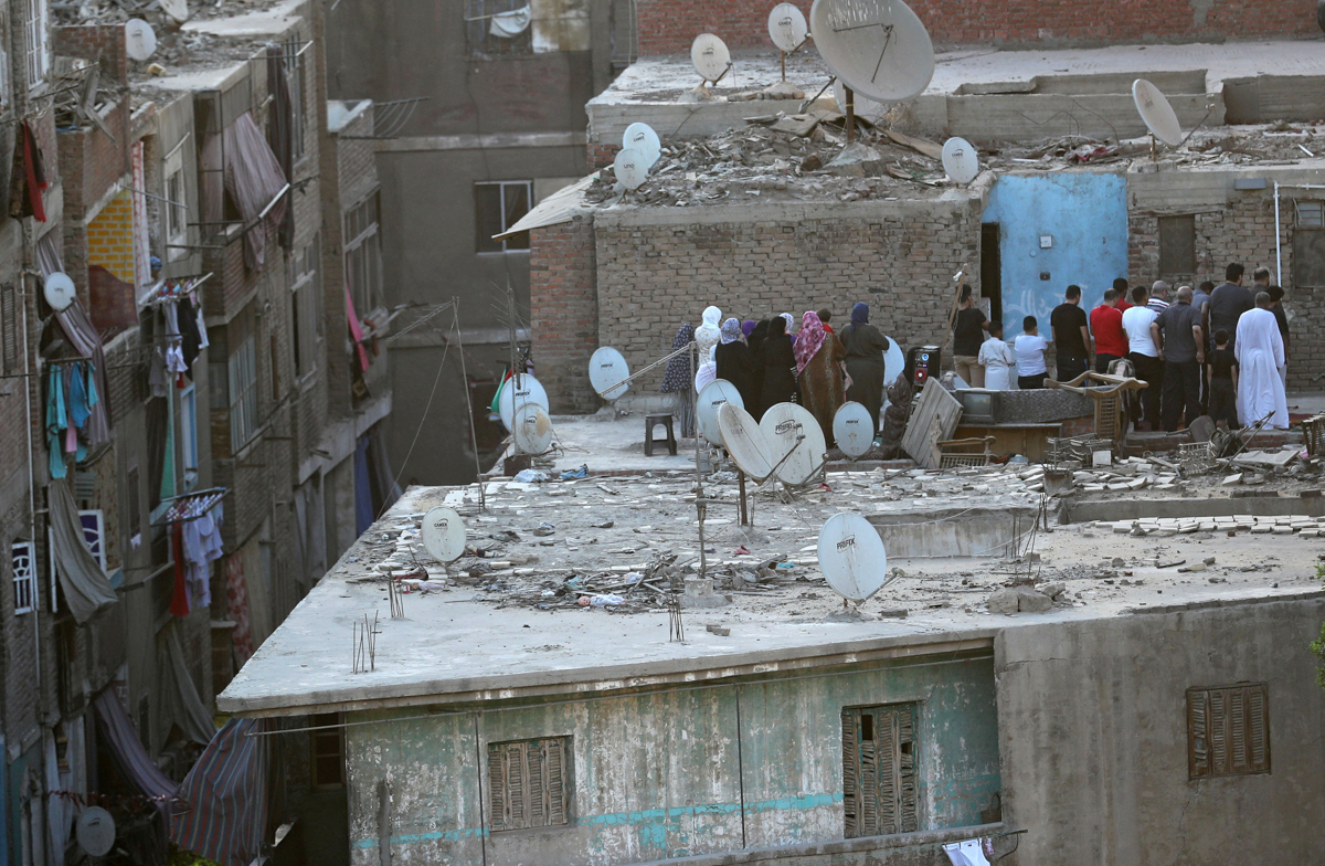 Egyptians perform Eid al-Fitr prayers, marking the end of the holy fasting month of Ramadan, on the roof of thier house, after mosques were shut amid concerns about the spread of the coronavirus disea