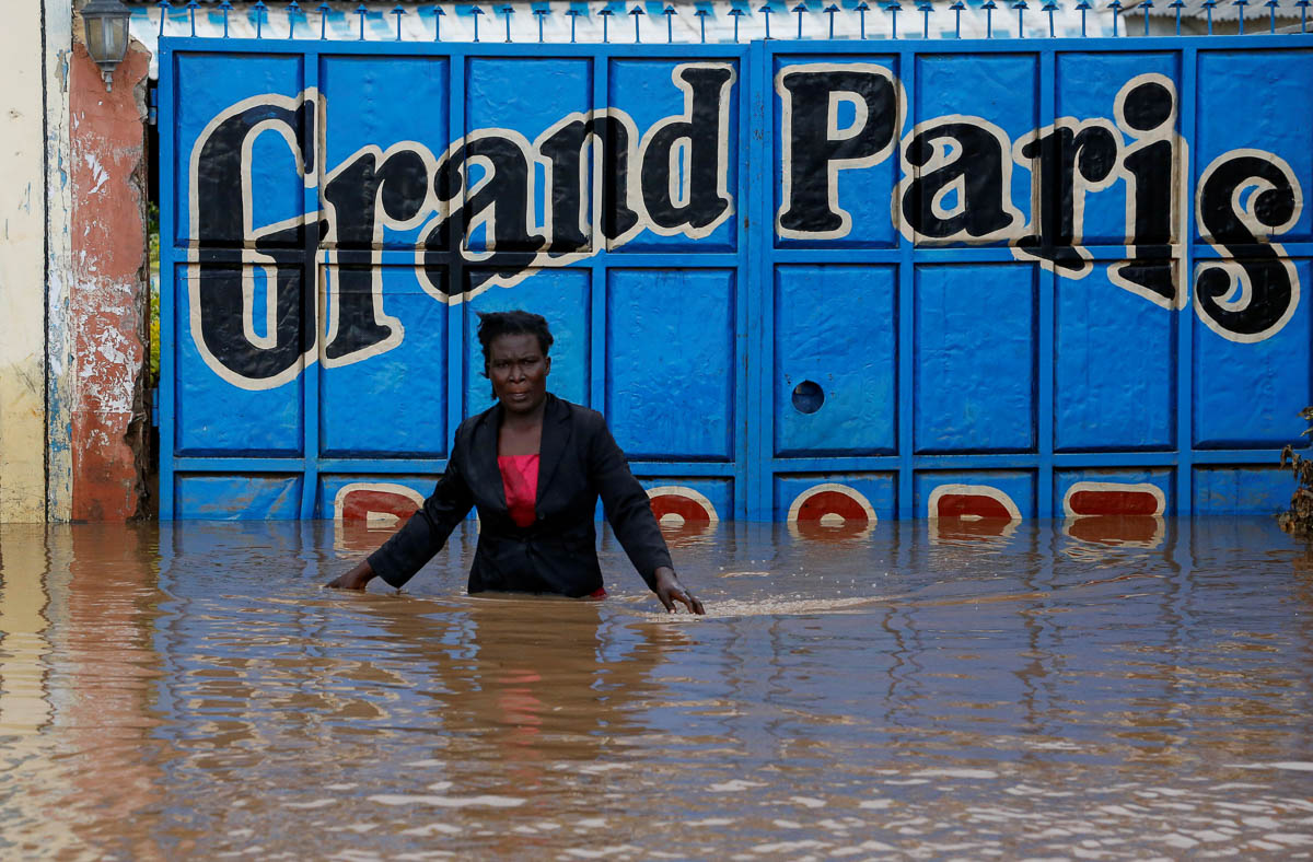 A trader, after securing the main entrance, walks from her premises after the River Nzoia burst its banks due to a backflow from Lake Victoria, in Nyadorera, Siaya County, Kenya May 2, 2020. REUTERS/T