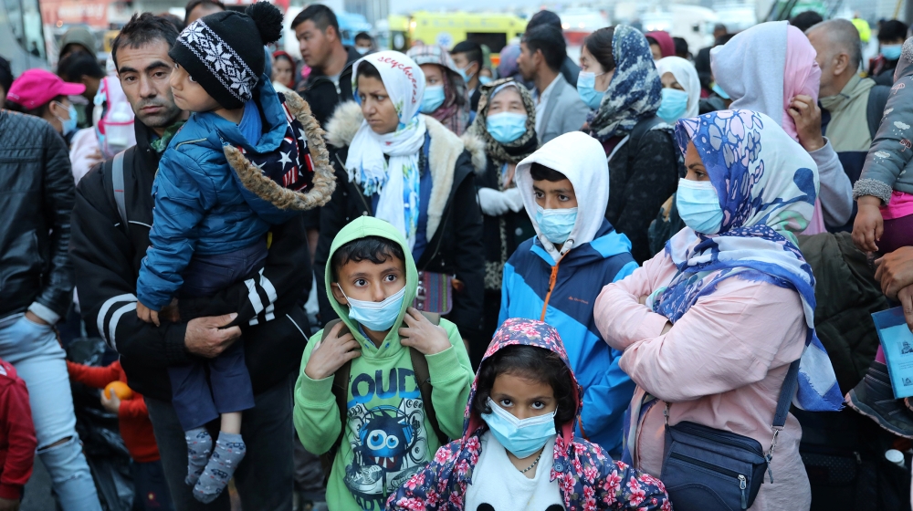 Migrants from the Moria camp in Lesbos wait to board busses at Piraeus port in Athens following the coronavirus disease (COVID-19) outbreak, Greece, May 4, 2020. REUTERS/Goran Tomasevic