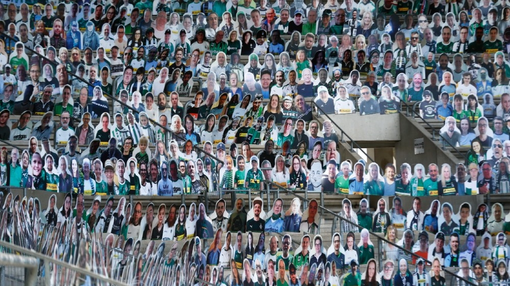 Life-size cardboard figures with the photos of football fans are positioned on the stands of the Borussia Moenchengladbach soccer stadium for the next game, which will be played withou